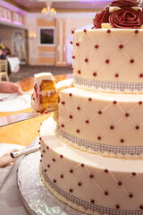 Wedding Cake portrait being sliced and served