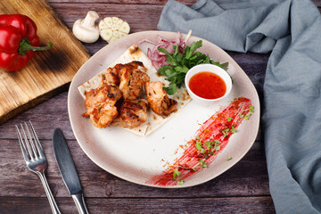 Grilled meat and vegetables on a white plate