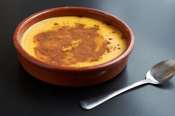 View of homemade custard on a black background.