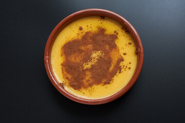 Top view of delicious homemade custard on black background.
