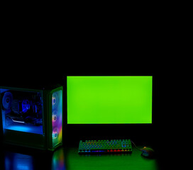 The gamer's room. Gamer desktop, monitor and PC with backlight. Modern gaming accessories. Keyboard, mouse with RGB light. Desktop PC with Rainbow fans