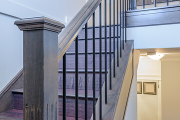 Beautiful living room interior with hardwood floors and vaulted ceiling in new luxury home. View of stairs, and second story loft style area.