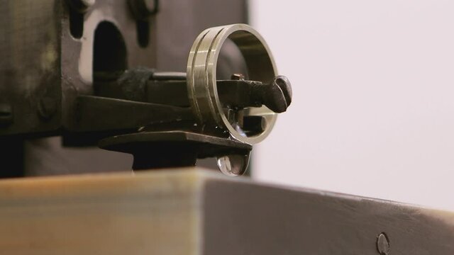 Close up shot of special machine for hallmarking jewelry , golden or silver ring . Process of probing , marking , creating precious ring . Jewellery industrial factory . 

