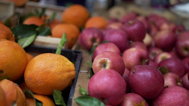 Fruits on display at food market, apples, tangeries, oranges for sale