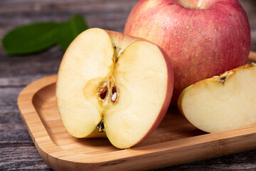 Ripe red apples on wooden table