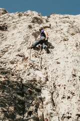 Obraz premium Man with helmet and equipped performs rock climbing in Etxauri, Navarra. 