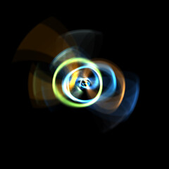 Spinning rays of light isolated on black background. Graphic 2D illustration of glowing colorful light particles in circular motion.