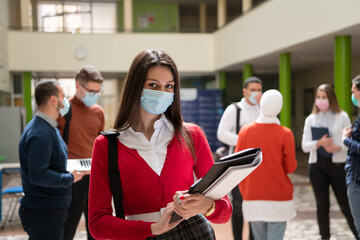 Portrait of multiethnic students group at university wearing protective face mask