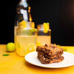 Brownies with lemonade on background