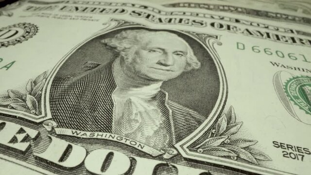 Very close detail images of George Washington portrait artwork on United States dollar bill paper fiat currency which is legal tender for all debts public and private.