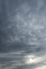 Vertical photo of a majestic gray sky with sun over horizon. No birds, no noise. Sun through stormy...