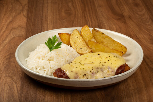 Parmigiana steak with rice and roasted potatoes. Typical Brazilian dish.
