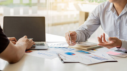 Fototapeta premium Businessman analyzes graphs, strategic planning and brainstorming of colleague's thinking ideas.