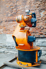 robotic arm against brick wall background
