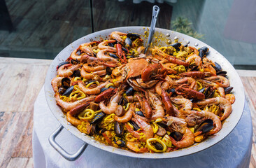 Big wook with paella with seafood outside