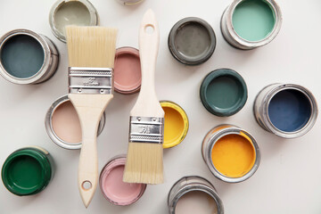 Overhead view of a DIY paint brush with colorful sample paint pots