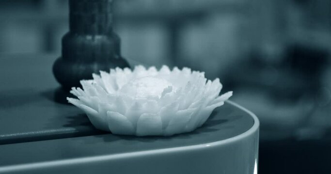 Abstract isolated object flower of yellow color printed on 3d printer