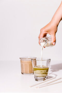 Pouring milk in matcha tea drink
