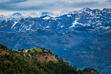 Fototapeta na wymiar Landscape with mountains. A serine village, in winter, in the lap of Dhauladhar range of Himalayan mountains, Himachal Pradesh India.