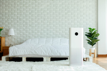 Air purifier in cozy white bedroom for filter and cleaning removing dust PM2.5 HEPA in home,for...