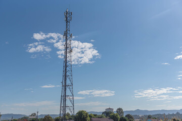 Obraz premium Cell phone data transmission tower on blue natural background