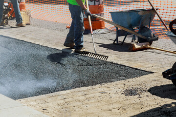 Construction site is worker laying new asphalt road