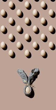 Chicken eggs Pattern and an Egg wrapped in napkin as Easter bunny form on beige background