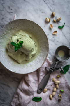 Pistachio Ice Cream with scoop in a rustic bowl