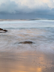 Wave water flowing into the ocean shore.