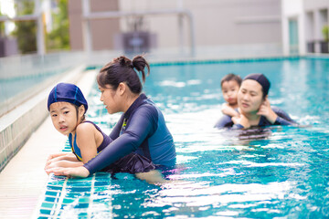 Portrait of girl swimming trainning with mother in residence
