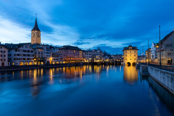 Fototapeta premium Panoramic view of historic Zurich city center with famous Fraumunster Church and river Limmat at Lake Zurich , in twilight, Canton of Zurich, Switzerland.