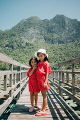 Fototapeta na wymiar Two cute little girls standing in bridge
