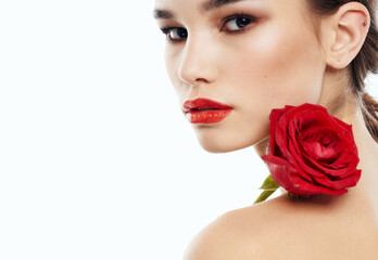 Obraz na płótnie Canvas Romantic woman with red fragrant flower near the face clean skin cosmetology dermatology