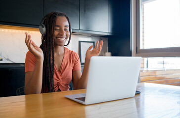 Woman on a video call with laptop at home.