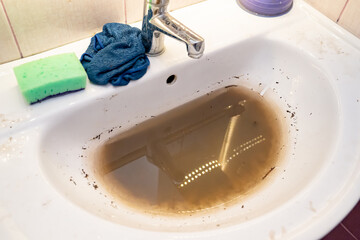 sink with dirty water because of the blockage. plumbing tool for mechanical cleaning of blockages...