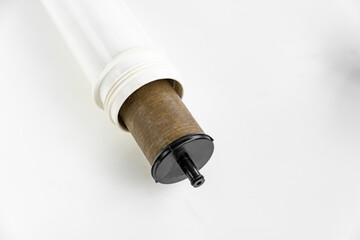 Dirty filter cartridge drinking water on a white background. Replacing cartridges is a mandatory procedure that must be carried out to maintain quality water purification. Pollution.