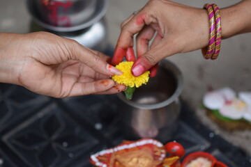 The transferring of flower from one hand to another in hindu & Indian rituals