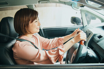 Asian woman driving car portrait