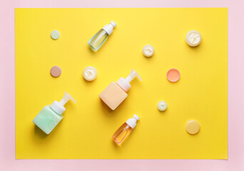 Bottles with different cosmetic products on color background