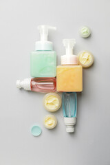Composition with bottles of cosmetic products on light background