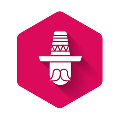 Fototapeta na wymiar White Mexican man wearing sombrero icon isolated with long shadow background. Hispanic man with a mustache. Pink hexagon button. Vector