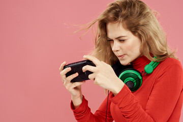 Woman headphones technology game entertainment pink background