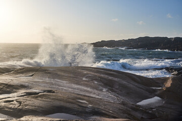 A big wave is comming in from the sea during a storm splashing over land