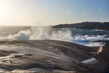 A big wave is comming in from the sea during a storm splashing over land