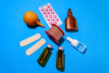 Drops in the nose, Band-Aid, vials, iodine, tablets are on the table
