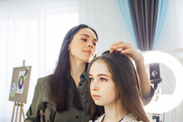 master makes a hairstyle for a girl, beautiful curls