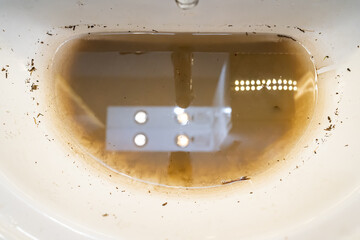 sink with dirty water because of the blockage. plumbing tool for mechanical cleaning of blockages...
