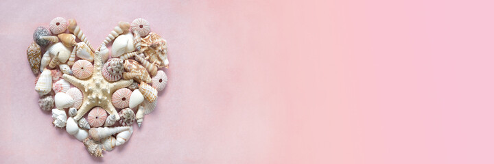 Summer season banner. Heart of starfish, sea urchins shells and seashells on a light pink background. Summer decor in a nautical style.Summer time banner