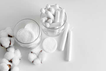 Glass jar with hygienic tampons and cotton flower