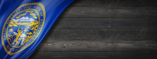 Nebraska flag on black wood wall banner, USA